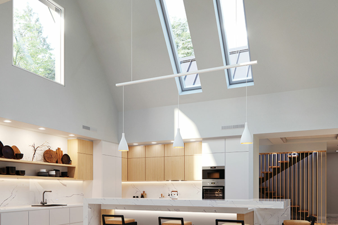 Two narrow and long, modern skylights in a sloped ceiling above a kitchen
