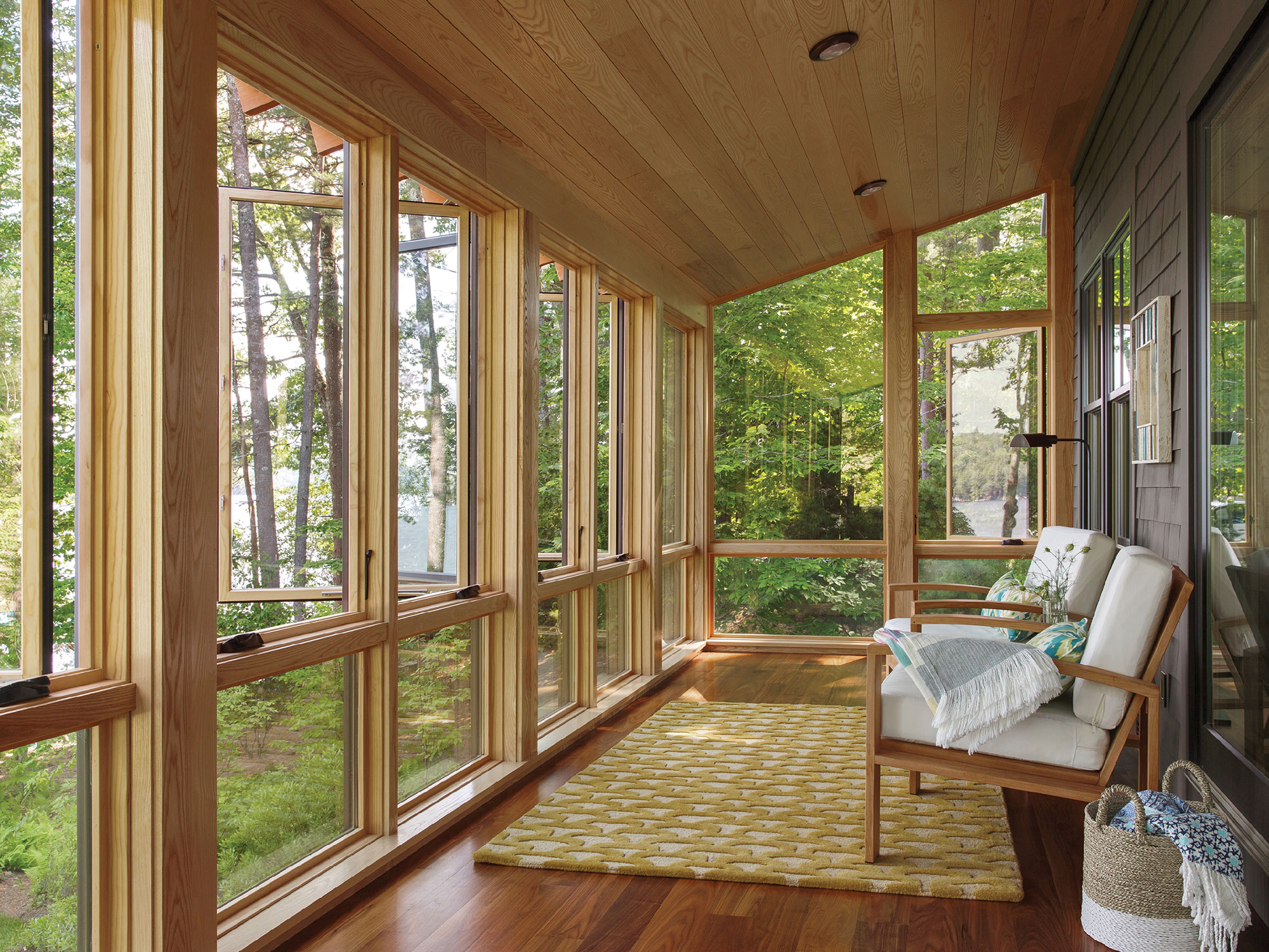 floor to ceiling windows line the perimeter of a porch structure