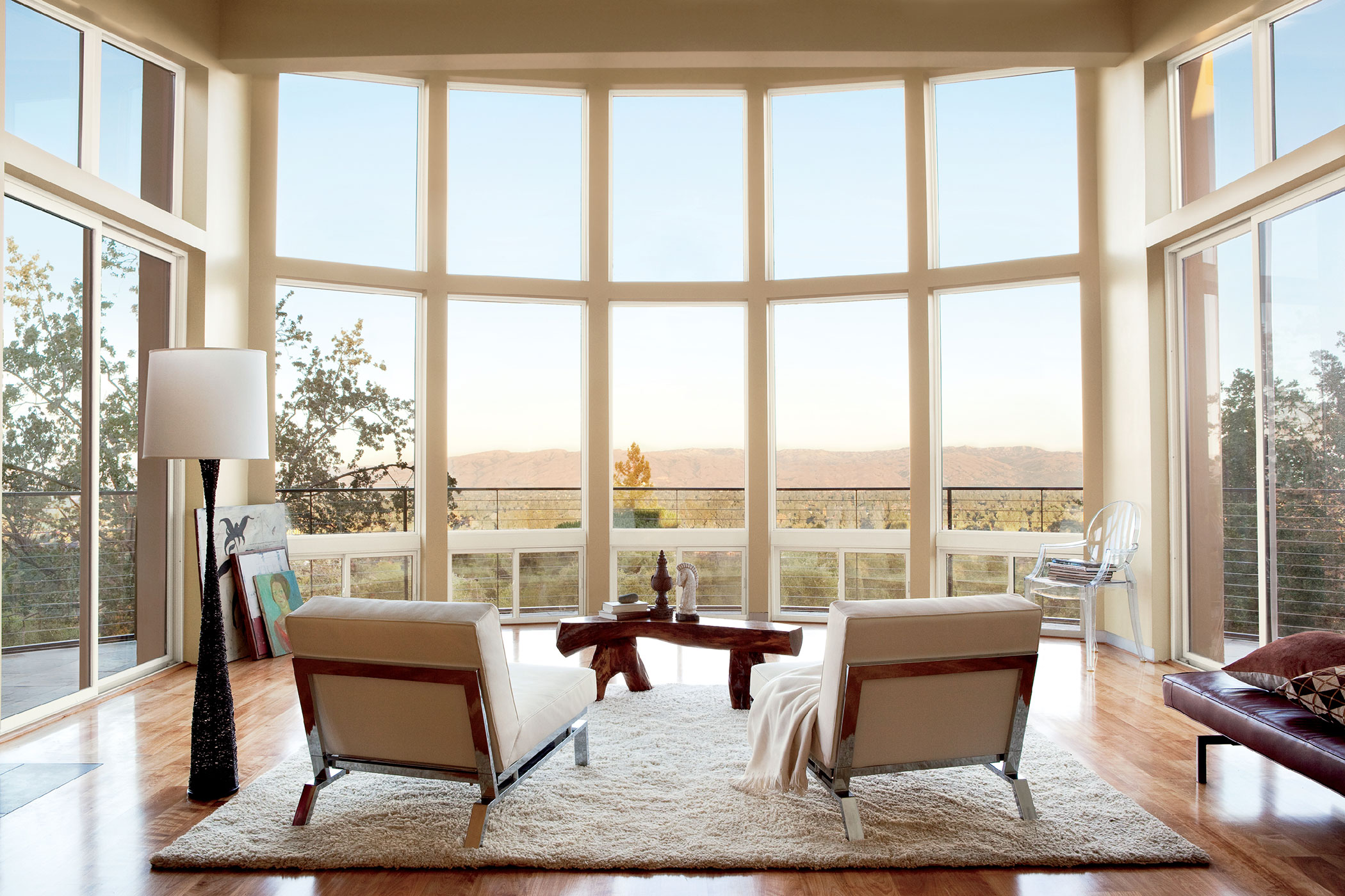 A curved wall of viewing windows with two chairs next to each other