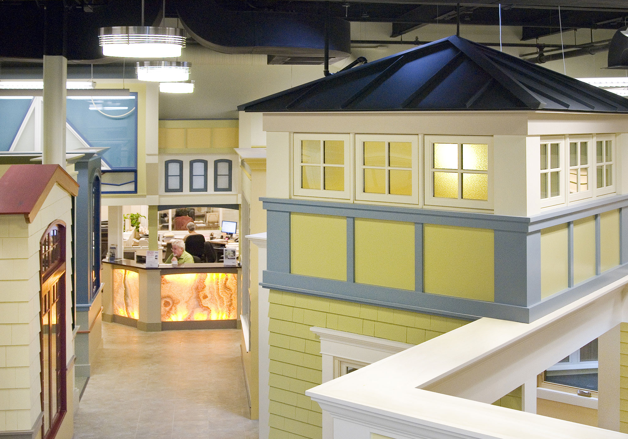 A window and door showroom with bright white structures, and colorful paint