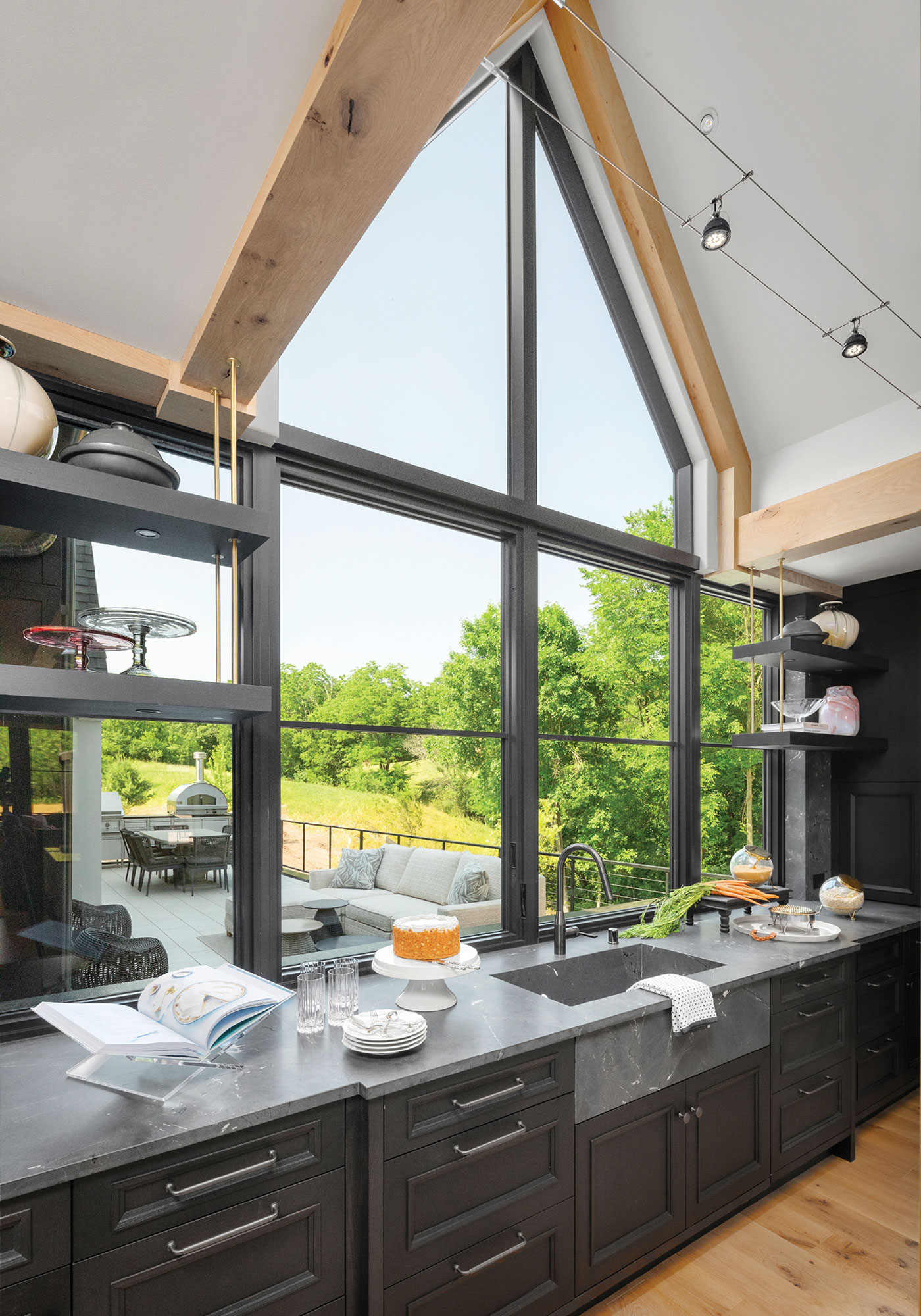 A brightly lit kitchen with massive windows over the sink and island areas