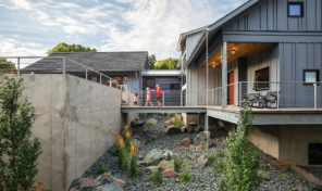 a cross walk connects the main house and the out building of a modern home.