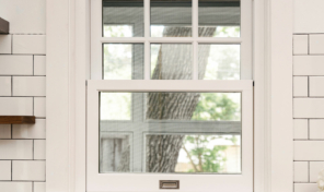 A window set into a white brick wall