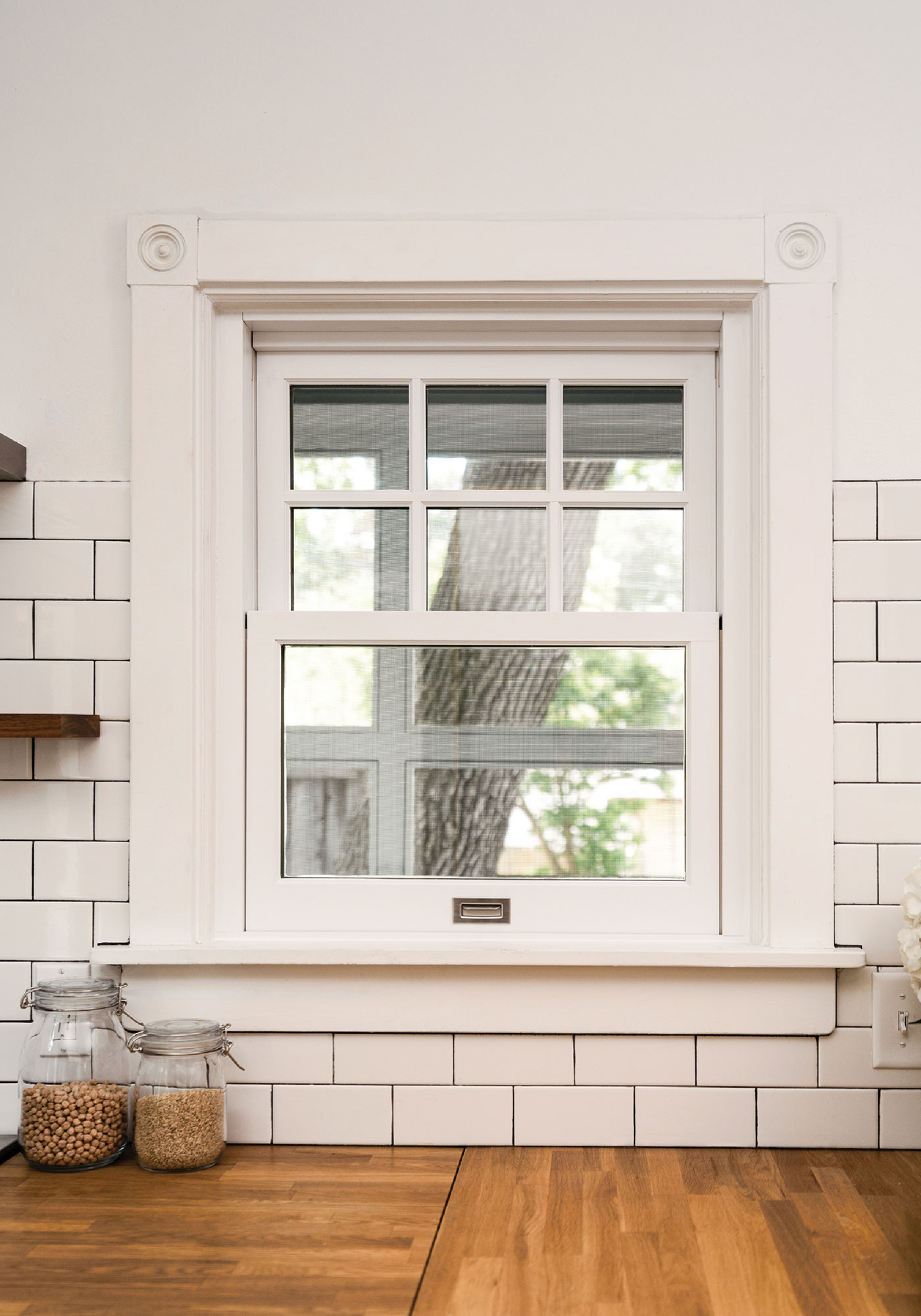 A window set into a white brick wall