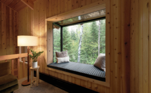 A Sky cove glass sitting area with wood paneling around it