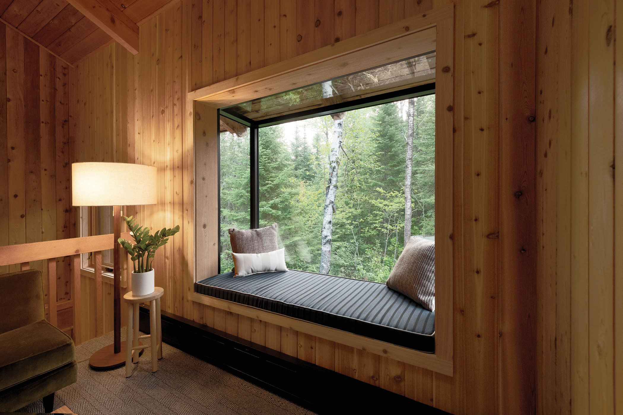 A Sky cove glass sitting area with wood paneling around it