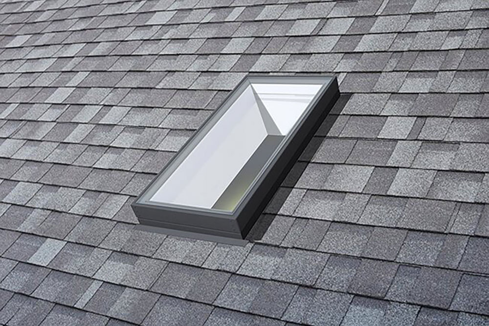 A single skylight in a roof with shingles around it